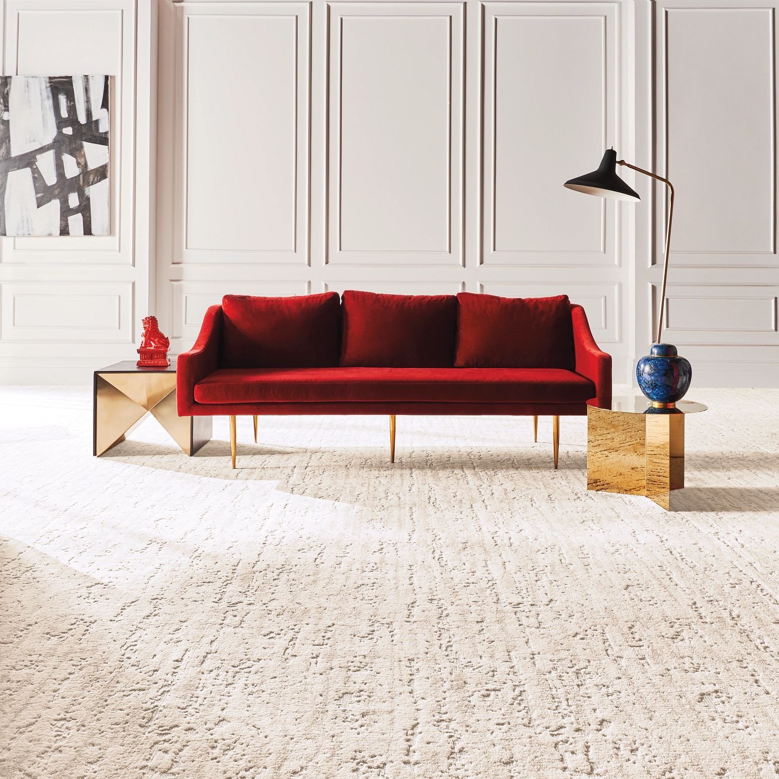 Bright living room with a red velvet couch and beige textured carpet from Simonian Flooring Inc in Village, NV