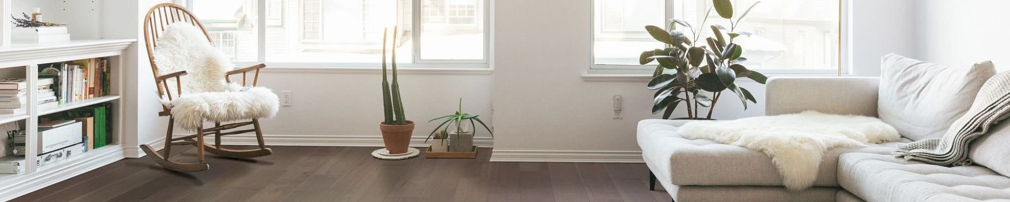 Living room with white furniture and hardwood flooring from Simonian Flooring Inc in Village, NV