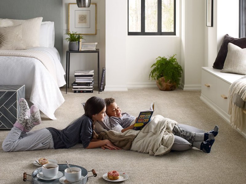 Kids reading on bedroom carpet from Simonian Flooring Inc in Village, NV